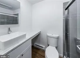 a white toilet sitting next to a bathroom sink