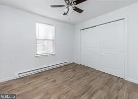 an empty room with a window and a ceiling fan