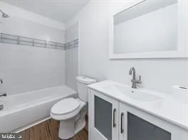 a bathroom with a sink a toilet and a bathtub