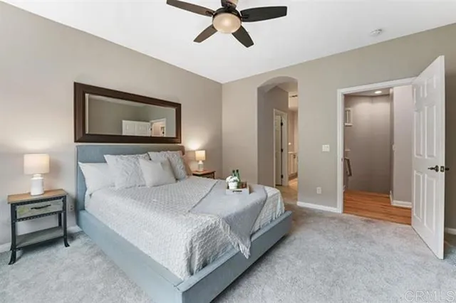 a bedroom with a bed and a painting on the wall