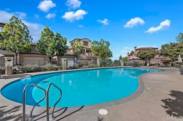 a view of a swimming pool with a table and chairs