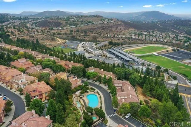 an aerial view of a city with mountains