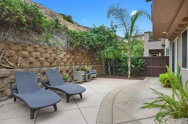 a view of a chairs and table in backyard