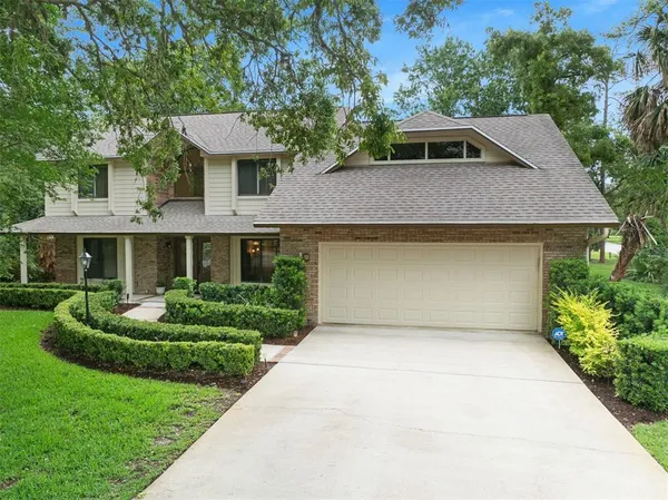 a front view of a house with a yard garage and outdoor seating