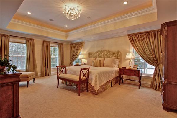 24 Hathaway Road Lexington, MA 02420 - Photo 1 of 28 a spacious bedroom with a bed and a chandelier