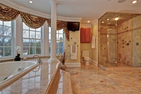24 Hathaway Road Lexington, MA 02420 - Photo 15 of 28 a bathroom with a large tub a sink and a large mirror