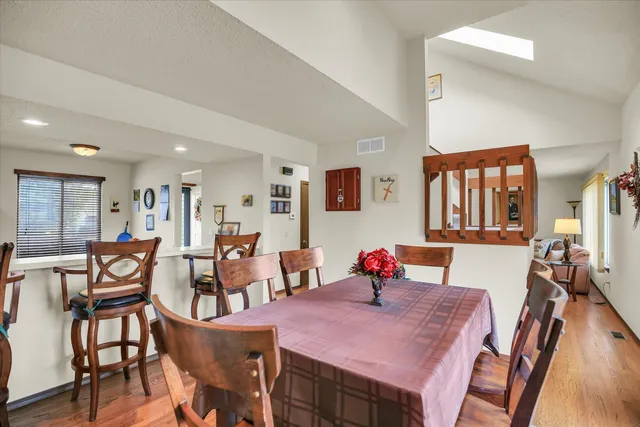 a view of a dining room with furniture and wooden floor