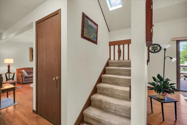 a view of entryway and hall with wooden floor