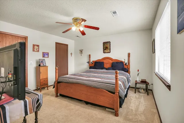 a bedroom with a bed and a chandelier