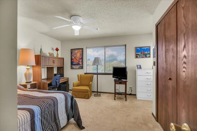 a bedroom with furniture and a flat screen tv