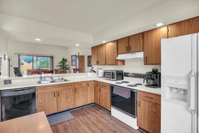a kitchen with a sink a stove a refrigerator and cabinets