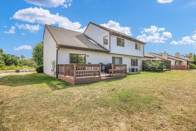 a view of a house with a yard and sitting area