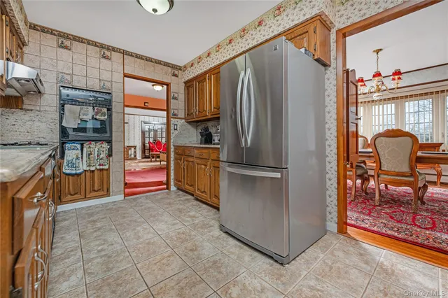 a kitchen with stainless steel appliances granite countertop a refrigerator and a stove