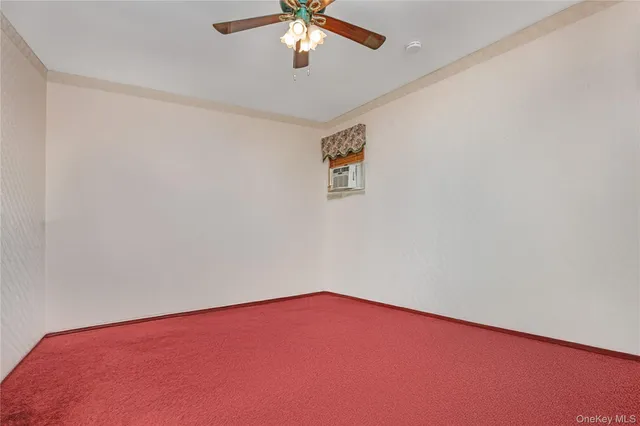 an empty room with a chandelier fan