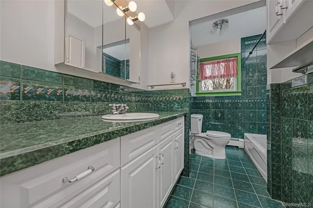 a bathroom with a sink a toilet and mirror