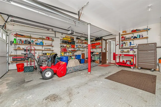 a front view of a house with a yard and lake view