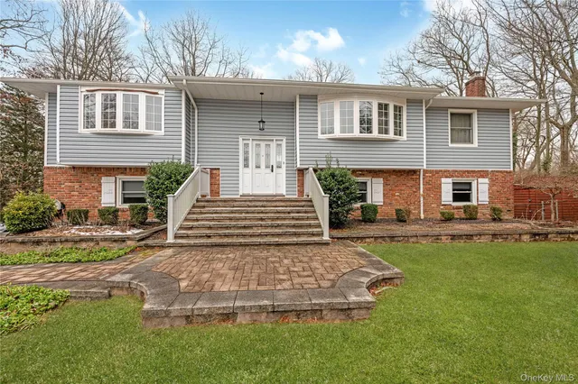 a view of a house with a yard patio and fire pit