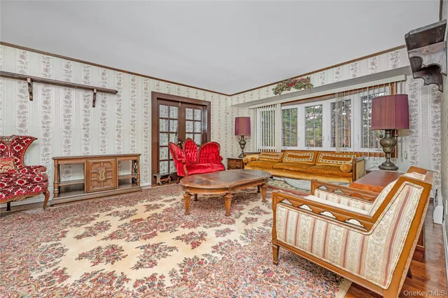 a living room with furniture a fireplace and a floor to ceiling window