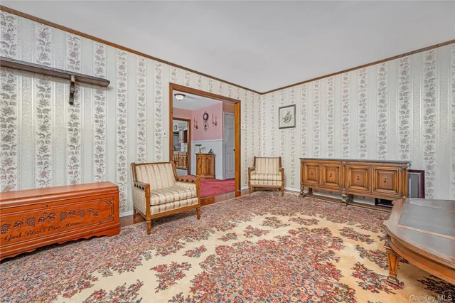 a bedroom with furniture and a rug