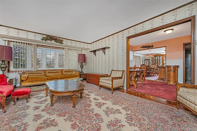 a living room with furniture a rug and a wooden floor