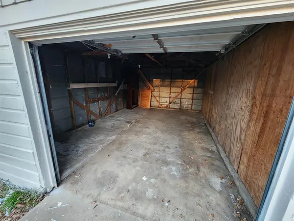 a view of empty room with wooden floor and windows