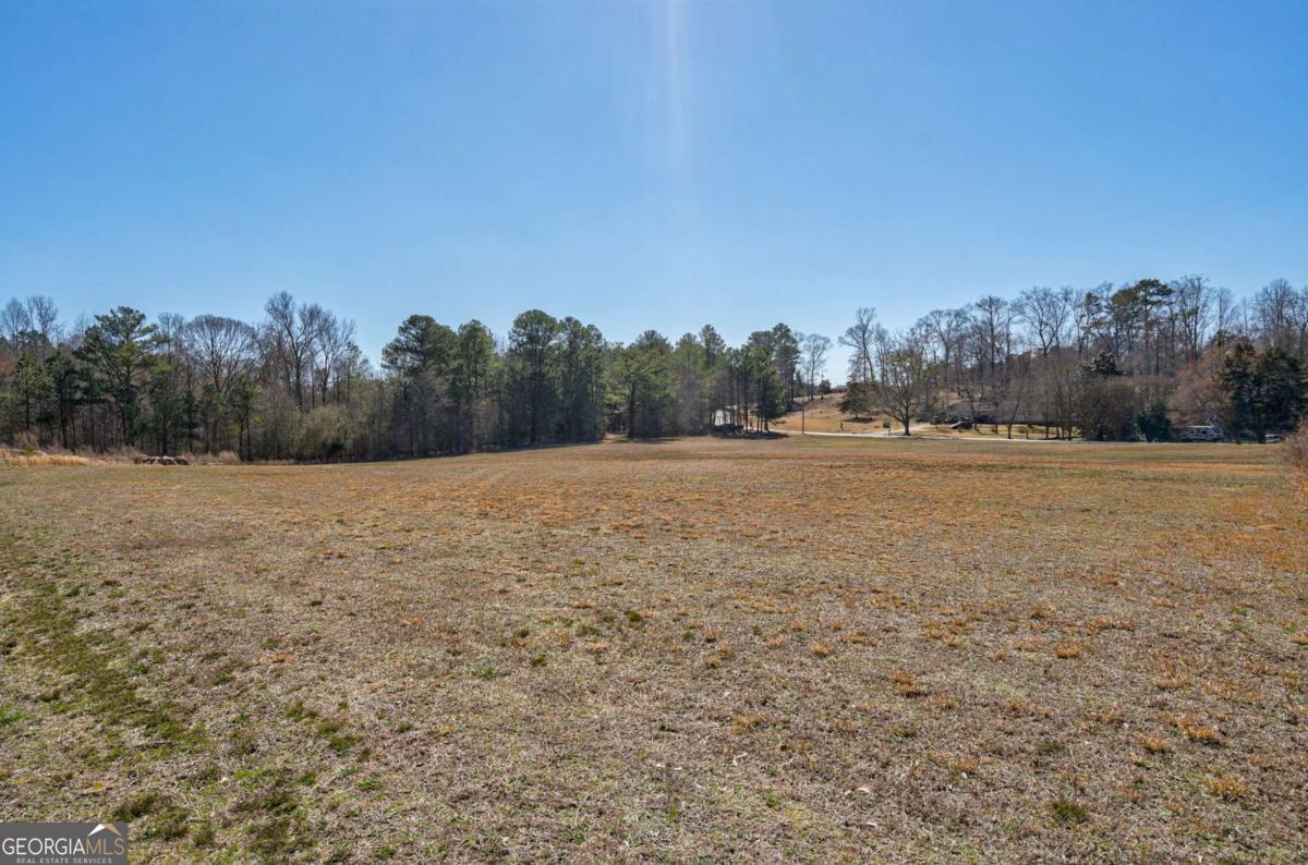 0 Kent Rock Road Loganville, GA 30052 - Photo 21 of 24 a view of a field with trees in background