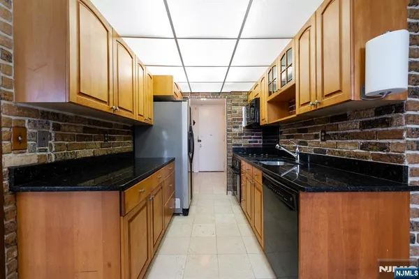 a kitchen with stainless steel appliances granite countertop a stove and a refrigerator