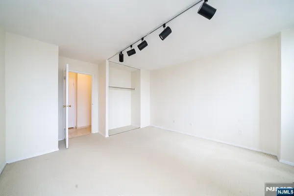 an empty room with a empty space and windows