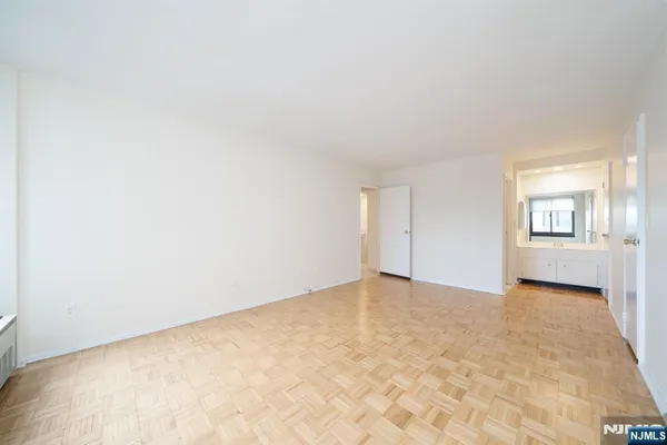 an empty room with windows and closet