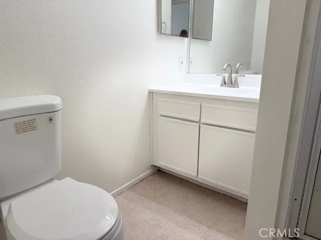 a bathroom with a glass shower door