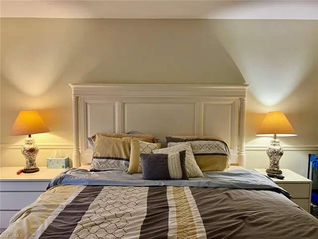 a bedroom with a bed and lamp