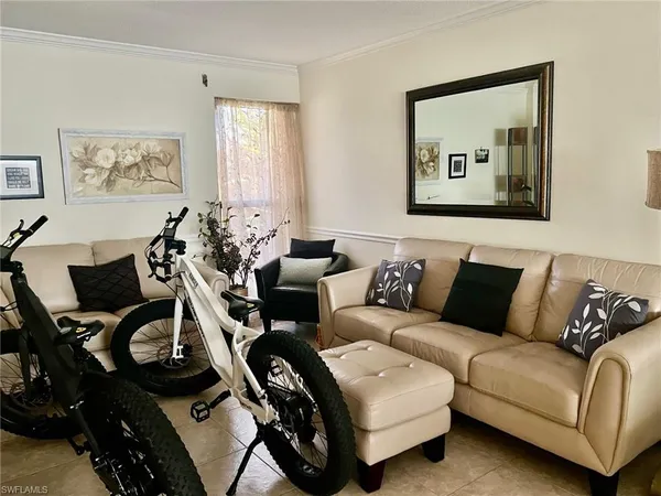 a living room with furniture a couch and painting on the wall