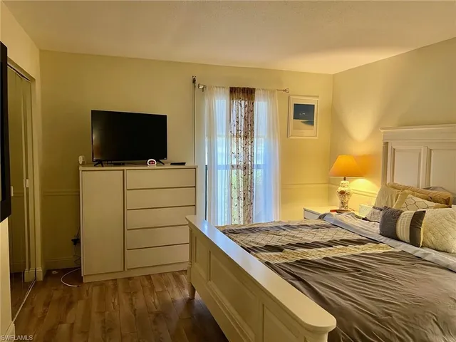 a bedroom with a bed and flat screen tv