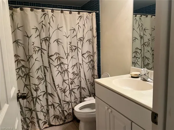 a bathroom with a sink toilet and a mirror
