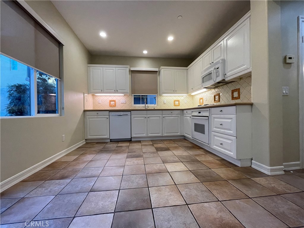 20 Arborside Irvine, CA 92603 - Photo 15 of 45 a kitchen with stainless steel appliances granite countertop a stove and a sink