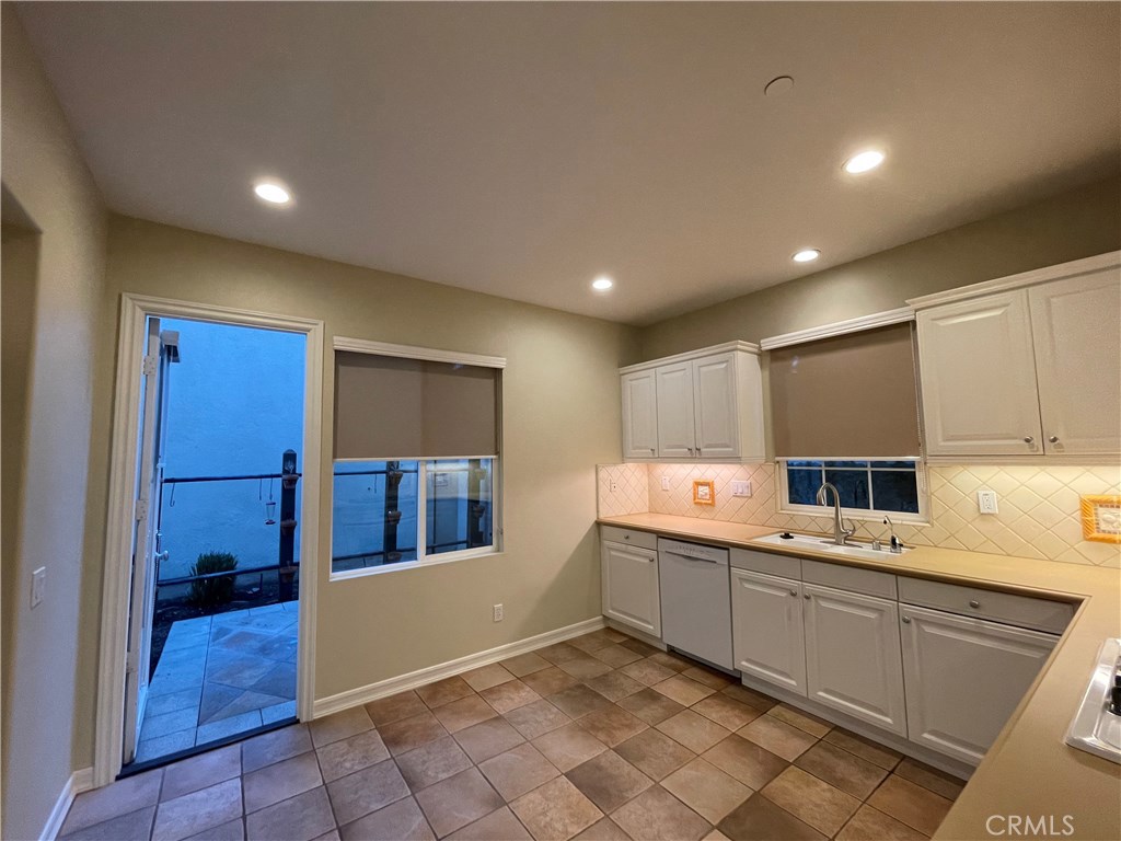 20 Arborside Irvine, CA 92603 - Photo 16 of 45 a kitchen with a sink a stove and cabinets