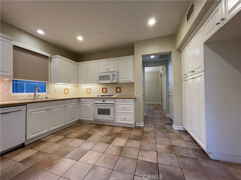 20 Arborside Irvine, CA 92603 - Photo 17 of 45 a kitchen with stainless steel appliances a stove sink and cabinets