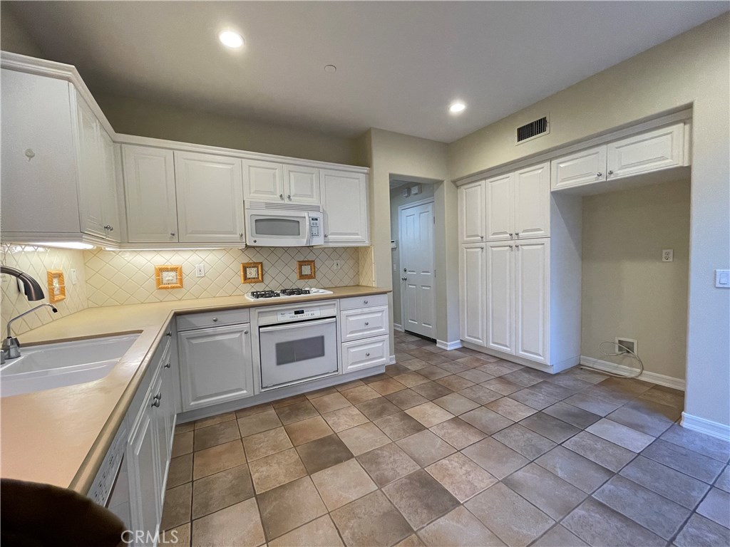 20 Arborside Irvine, CA 92603 - Photo 18 of 45 a kitchen with stainless steel appliances granite countertop a sink and cabinets