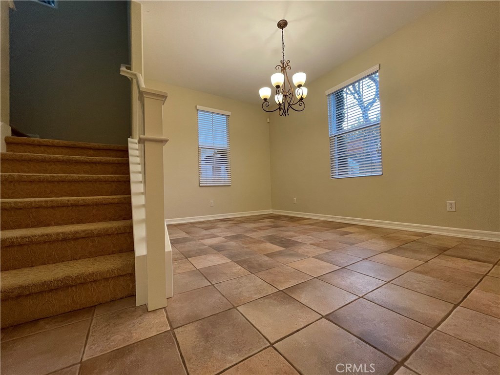20 Arborside Irvine, CA 92603 - Photo 20 of 45 a view of a livingroom with a chandelier fan and kitchen view