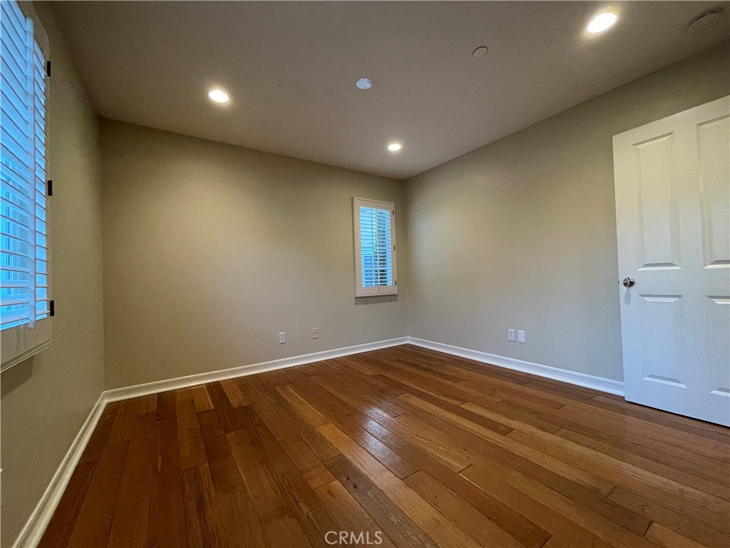20 Arborside Irvine, CA 92603 - Photo 29 of 45 an empty room with wooden floor and windows