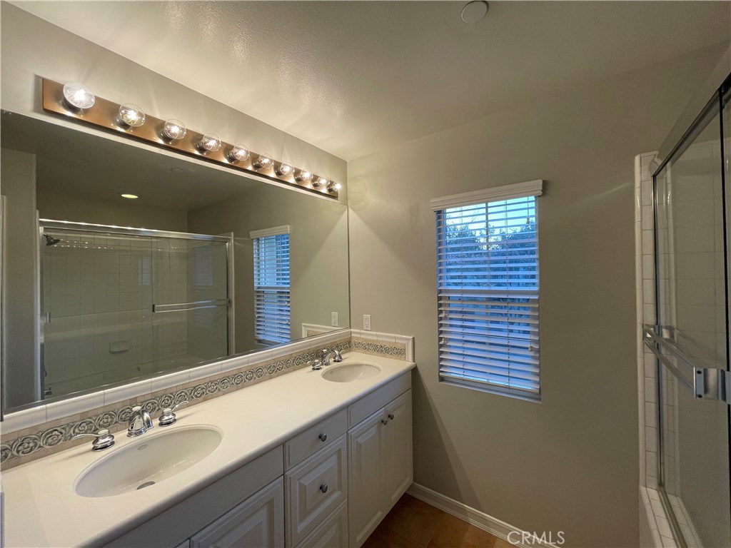20 Arborside Irvine, CA 92603 - Photo 38 of 45 a bathroom with a double vanity sink and a mirror