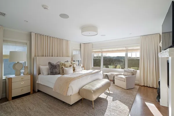 a bedroom with a bed and a large window