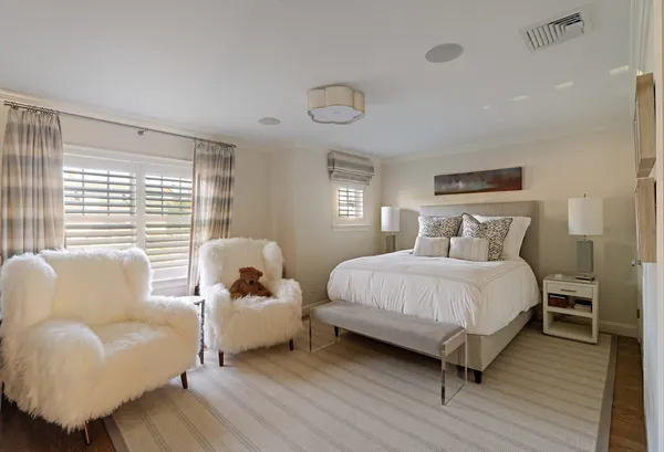 a bedroom with furniture and a window