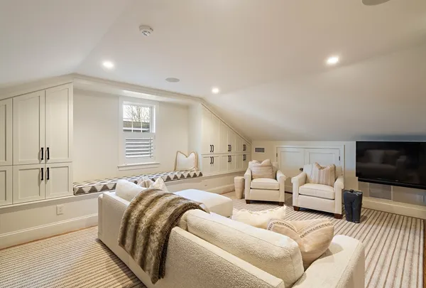 a spacious bedroom with a bed a couch and a flat screen tv