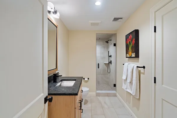 a bathroom with a sink a mirror and shower
