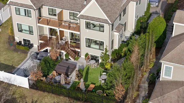 an aerial view of multiple houses with yard