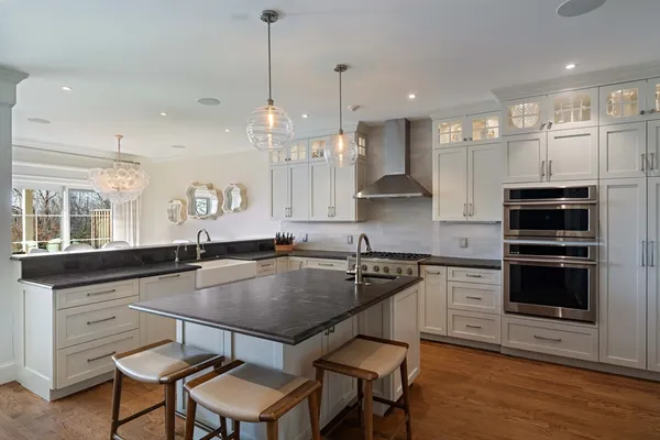 a kitchen with a table chairs stove and kitchen island