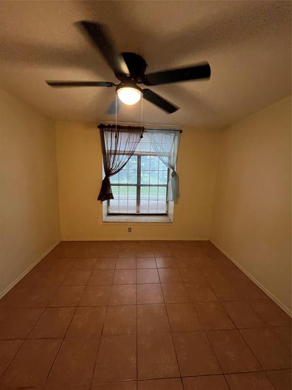 4460 Chaha Road, Unit 205 Garland, TX 75043 - Photo 20 of 27 an empty room with windows and ceiling fan
