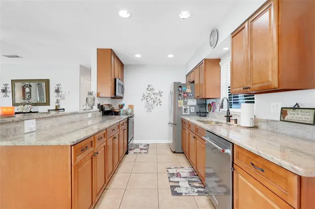 a kitchen with stainless steel appliances granite countertop a sink and a stove