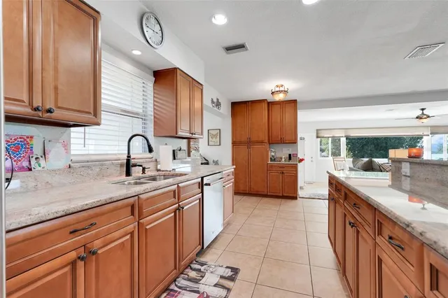 a kitchen with stainless steel appliances a sink stove and cabinets